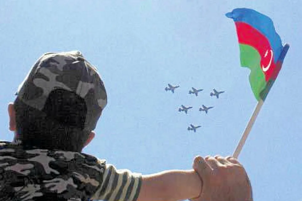 an Azeri boy waves the national flag in Baku