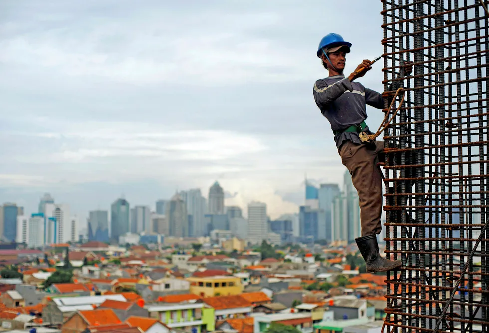 High rise: a worker at a construction site in the indonesian capital Jakarta