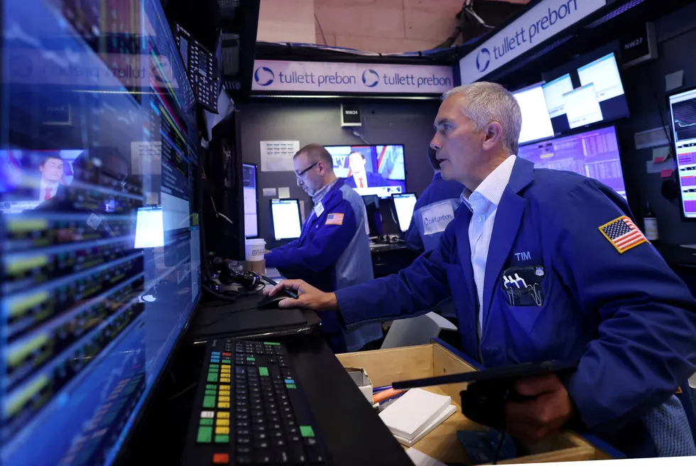 Traders work on the trading floor at the New York Stock Exchange.