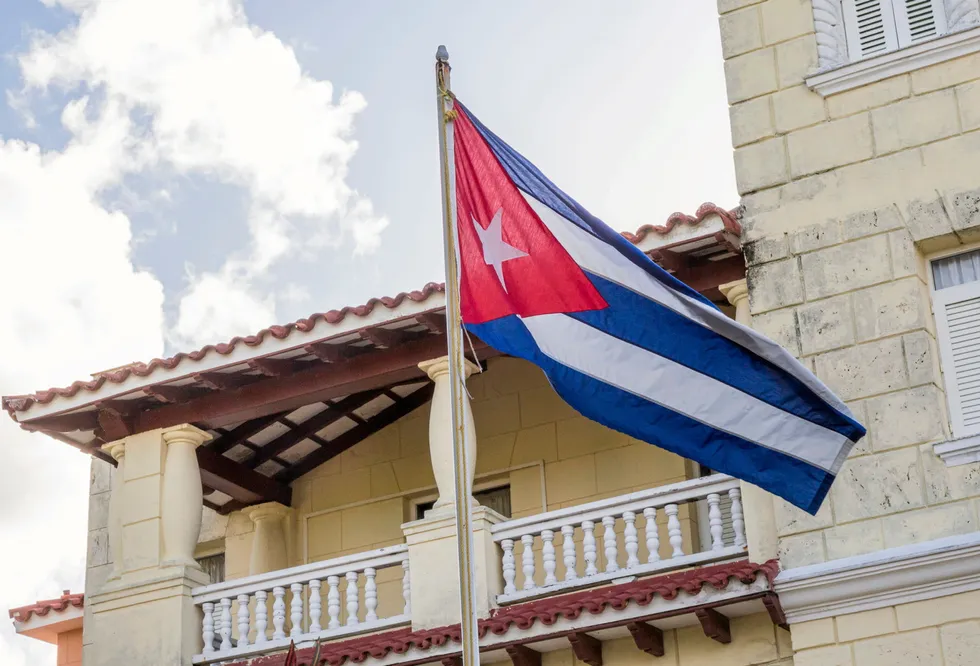 The Cuban flag: flies on a building in Cuba.