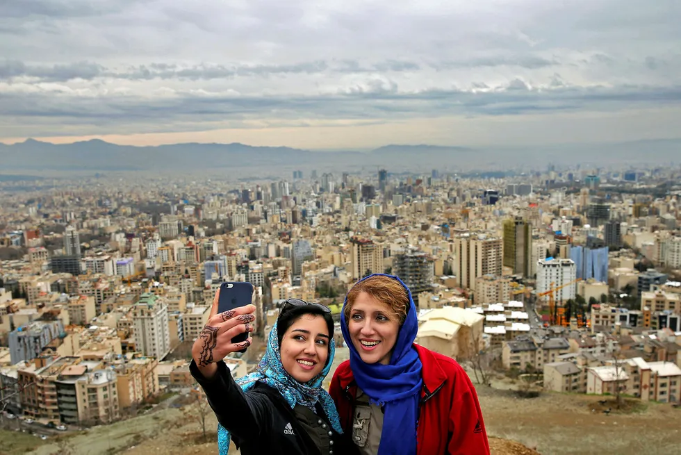 Day out: Iranian women take a selfie overlooking Tehran