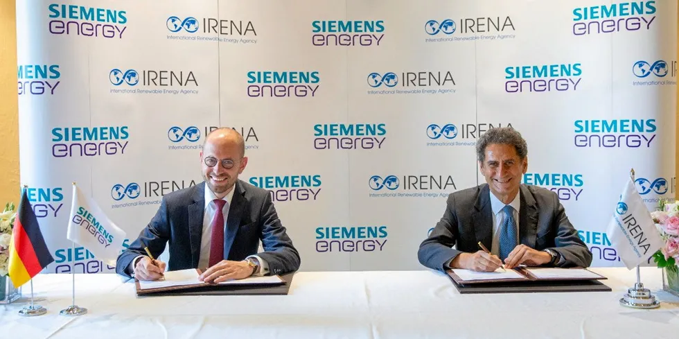Siemens Energy CEO Christian Bruch, left, and Irena boss Francesco La Camera sign the partnership agreement in Abu Dhabi.
