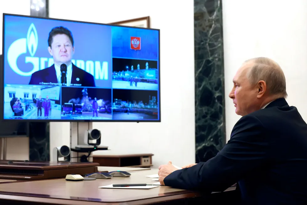 Screen call: Russian President Vladimir Putin (right) listens to Gazprom executive chairman during a teleconference call.