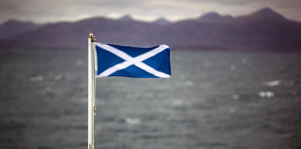 Scotland's Saltire flag in the wind on board the Hebrides Caledonian MacBrayne ferry