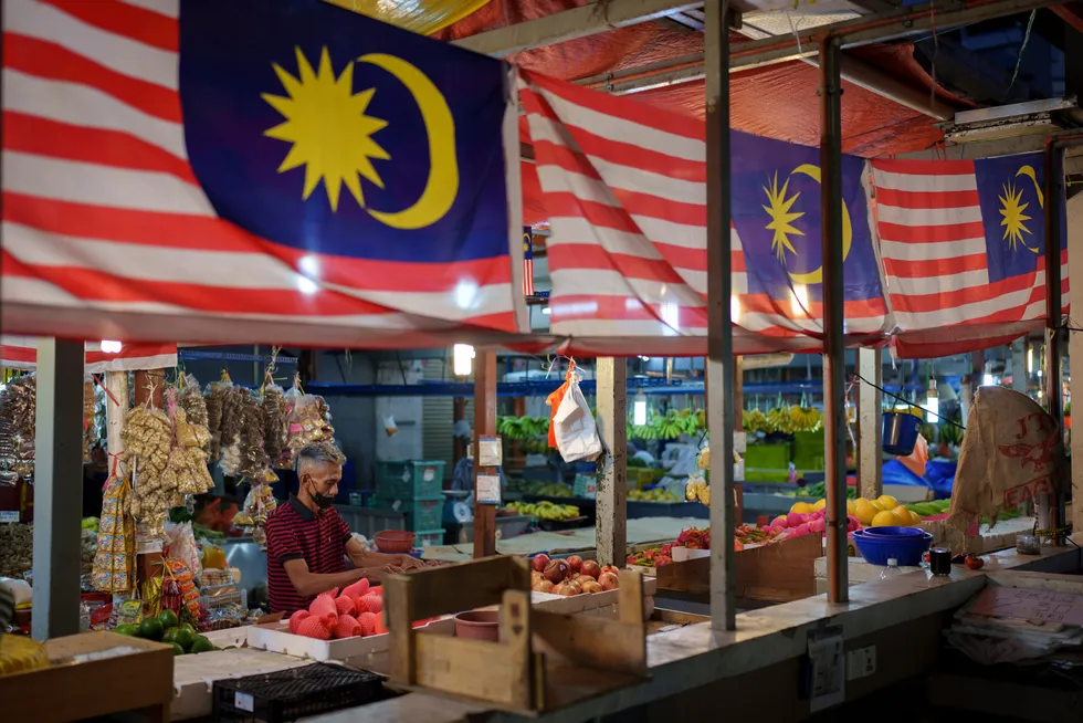 Malaysian delicacies: a vendor prepares to start the day at a wet market in downtown Kuala Lumpur