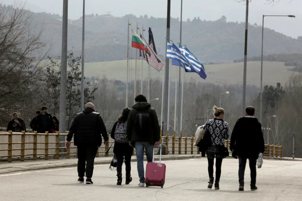 Passage allowed: people approach a border crossing point near Kulata, Bulgaria, to cross into Greece