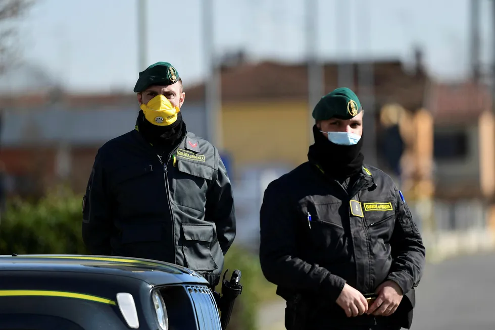 Global outbreak: Italian Finance guards (Guardia di Finanza) officers patrol by a check-point in the red zone of the COVID-19 outbreak in northern Italy