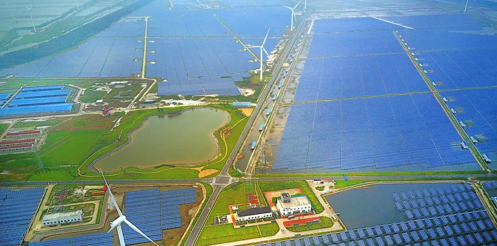 Aerial view of an industrial base with wind turbines, solar panels and fish ponds at tidal flats in Yancheng, Jiangsu Province, China