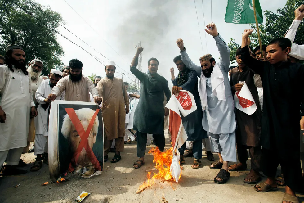 Pakistani protesters shout slogans to condemn a cartoon contest by Dutch parliamentarian, in Peshawar, Pakistan, Friday, Aug. 17, 2018. Pakistan has approached Organization of Islamic Cooperation (OIC) to lodge a protest against a cartoon competition in Netherlands by politician Geert Wilders. (AP Photo/Muhammad Sajjad) ---