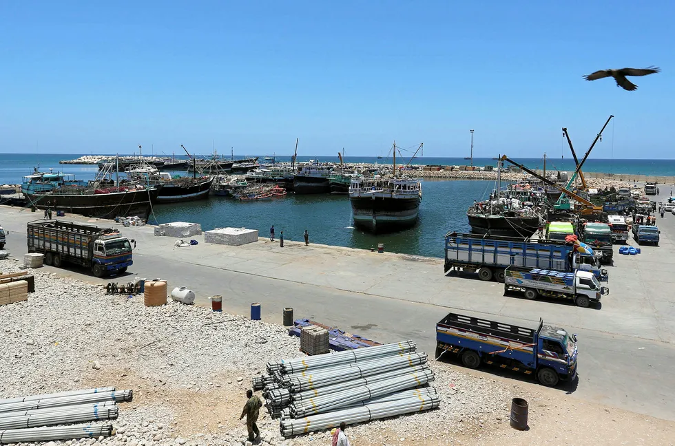 Looking to the horizon: the Port of Bosaso in Somalia's Puntland and, inset, demonstrators outside the venue in London where the Federal Government of Somalia was promoting an oil and gas licence offering this week