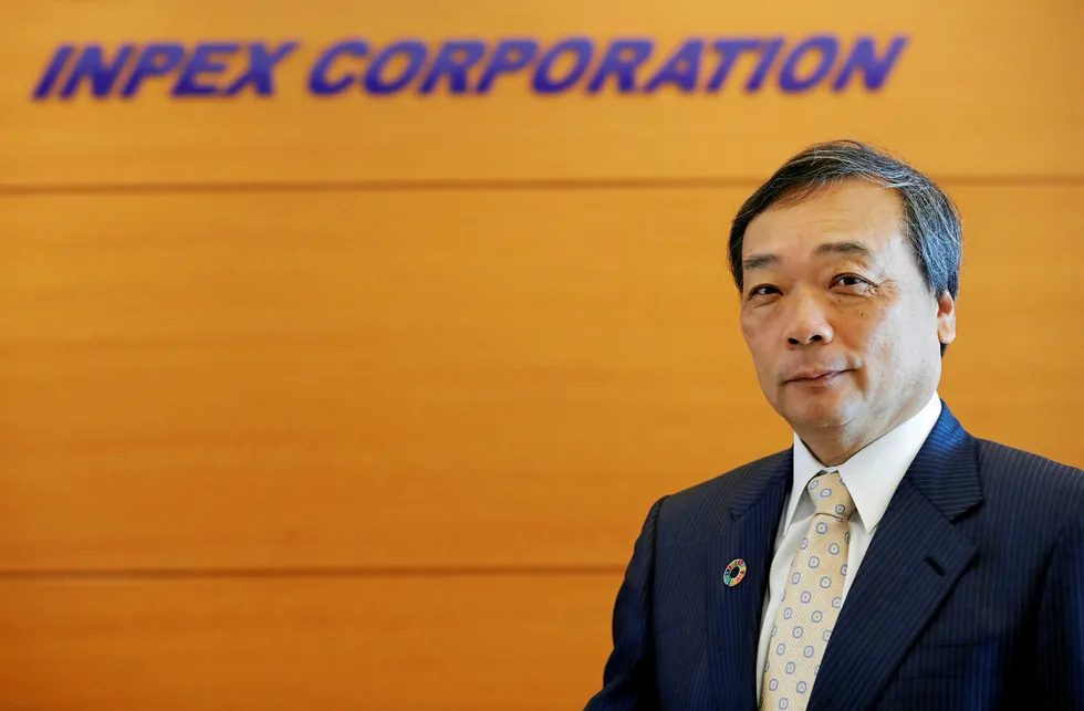 Tough quarter: Inpex chief executive Takayuki Ueda poses in front of his company's logo