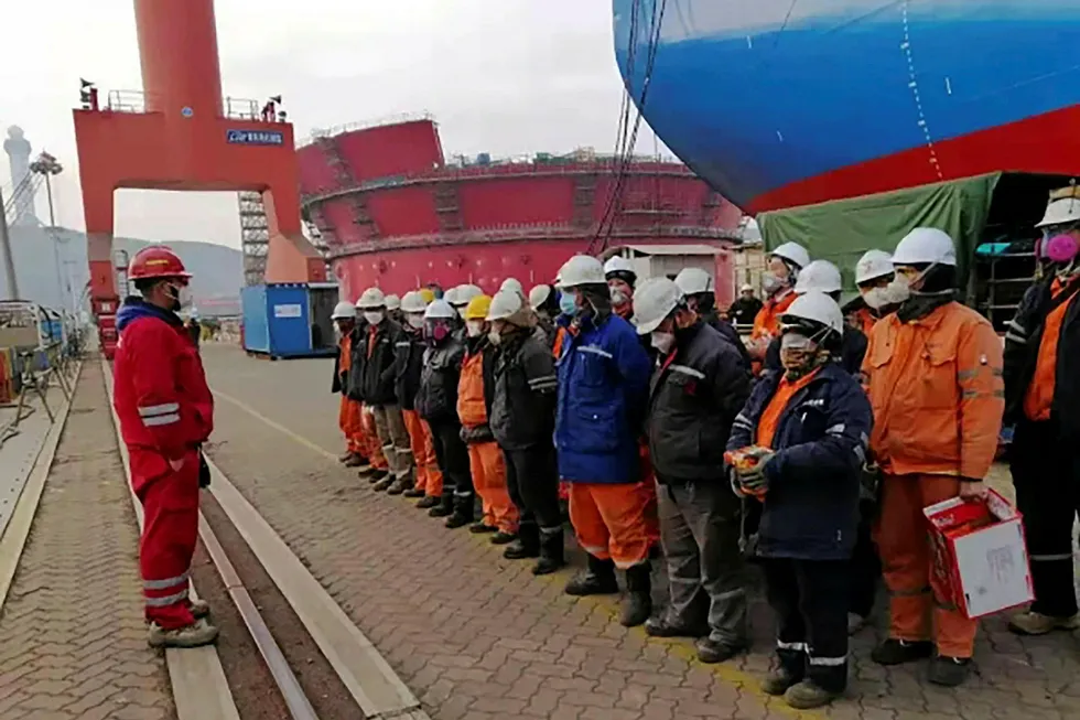 Ready to board: Workers receive precautionary tips for avoiding Covid-19 before starting their shift on Shell's Penguin FPSO at COOEC Qingdao yard