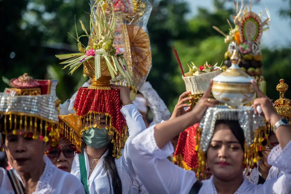 Ritual: people prepare to take part in a Melasti ceremony prayer at the Segara temple in Surabaya, East Java, Indonesia.