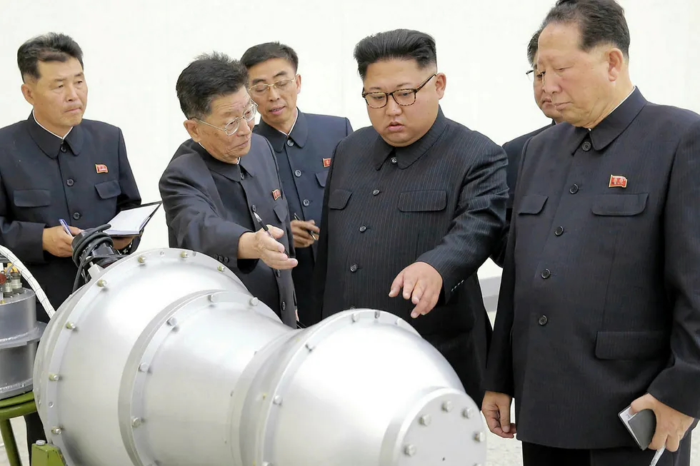 Trouble brewing: North Korean leader Kim Jong Un, second from right, in a photo distributed by the North Korean government