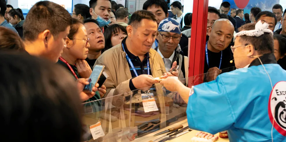 Visitors crowd a stand at the 2018 China Fisheries & Seafood Show.