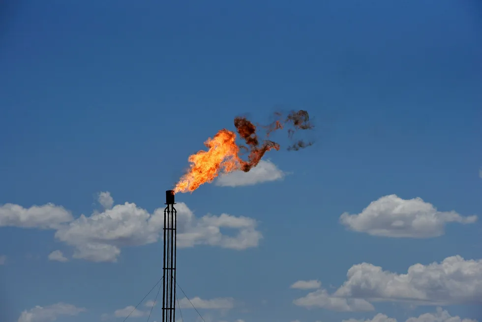 Controversy: a flare burns off excess gas from a gas plant in the Permian basin oil production area near Wink, Texas
