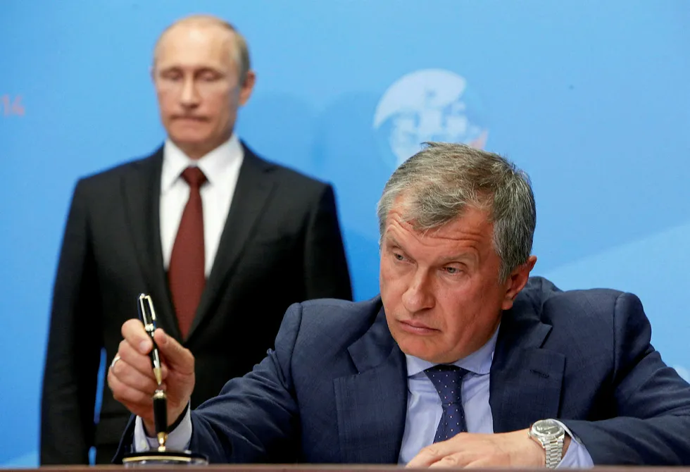 Russia's President Vladimir Putin (back) and Rosneft chief executive Igor Sechin