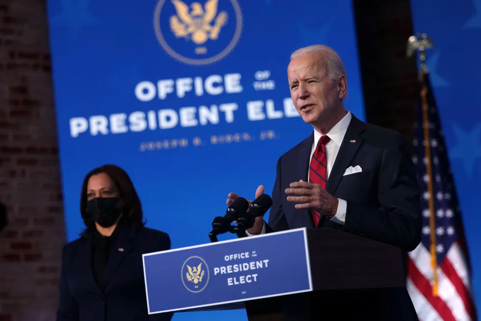 US President-elect Joe Biden (R) speaks as US Vice President-elect Kamala Harris (L) looks on during day two of laying out his plan on combating the coronavirus