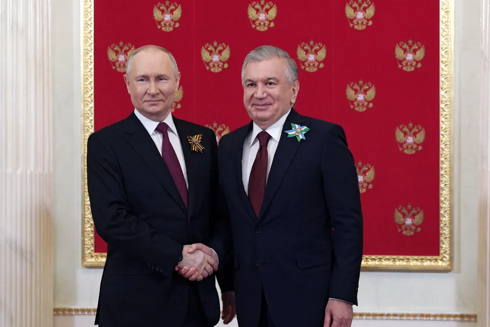 Handshake: Russian President Vladimir Putin (left) with Uzbekistan President Shavkat Mirziyoyev before a military parade on Victory Day in Moscow on 9 May.