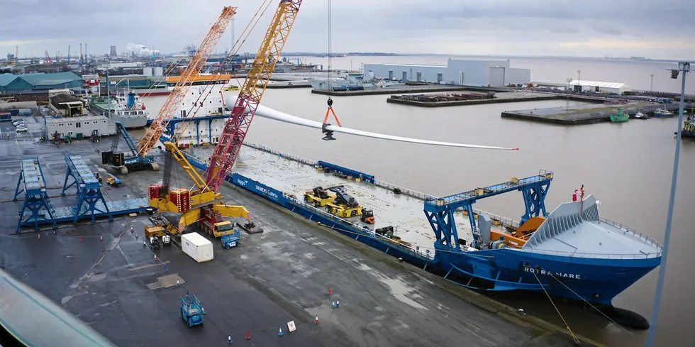 Siemens Gamesa 108-metre-long blade being loaded on a transport vessel.