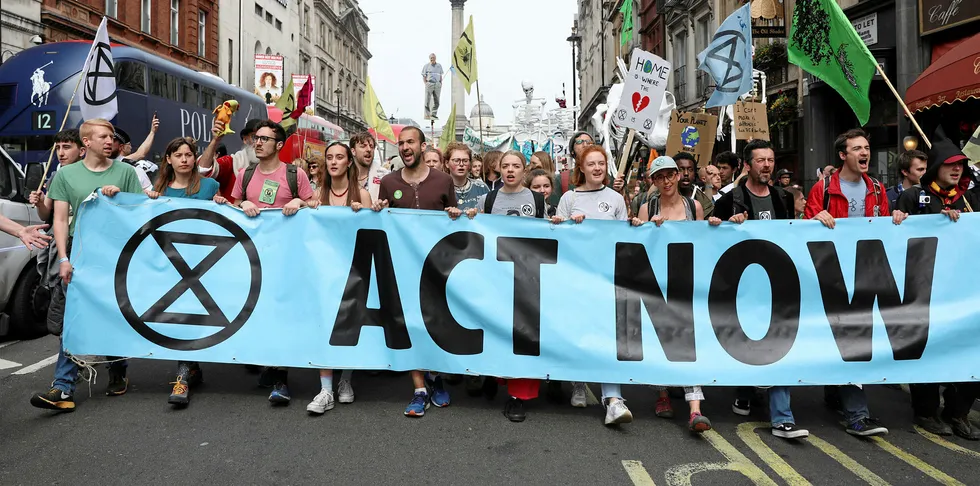 Climate change activists from the group Extinction Rebellion march down Whitehall as they protest in central London.