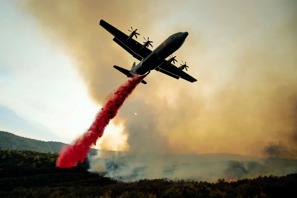 (FILES) In this file photo taken on August 05, 2018 An air tanker drops retardant on the Ranch Fire, part of the Mendocino Complex Fire, burning along High Valley Rd near Clearlake Oaks, California. Two blazes mercilessly charring northern California have grown so rapidly that they became the US state's largest in recorded history Monday August 6, 2018, authorities said. / AFP PHOTO / NOAH BERGER ---