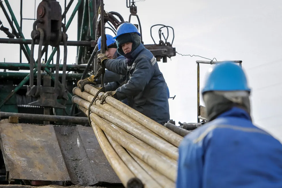 Frontier: workers prepare pipes to service an oil well in Kyzylorda region, southern Kazakhstan.