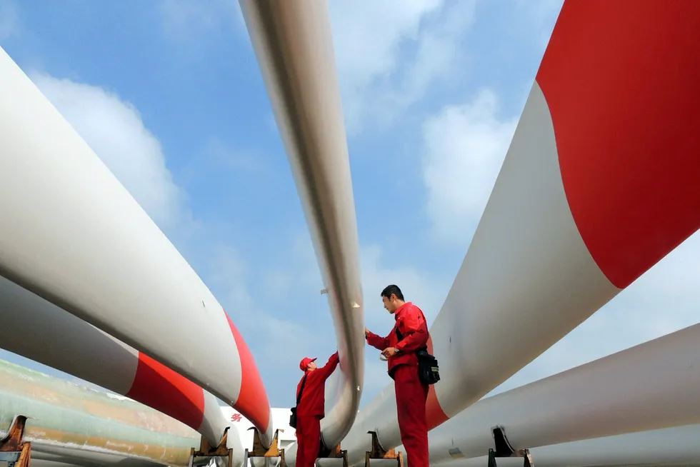 Cutting edge: labourers check the quality of wind turbine blades in China's Jiangsu province. Chinese yards are among the world’s busiest in building offshore wind farm installation vessels