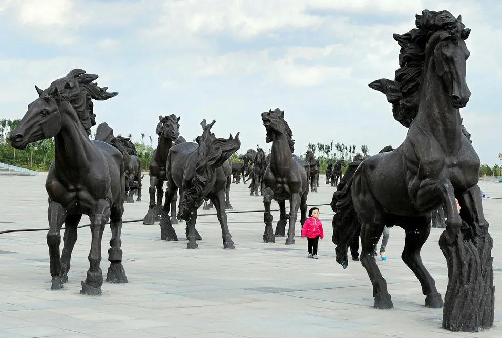 Long ride: a young girl walks amongst horse statues built as a tribute to Genghis Khan, whose unmarked tomb is claimed to be nearby, in the city of Ordos, in Inner Mongolia