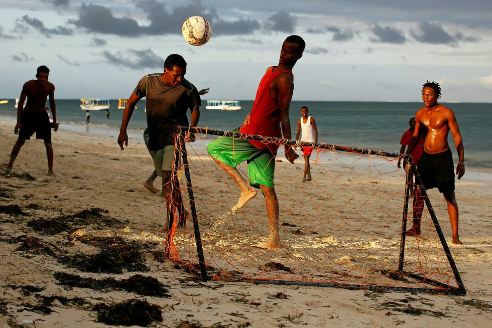 Mixed results: men play beach football in Mombasa, Kenya
