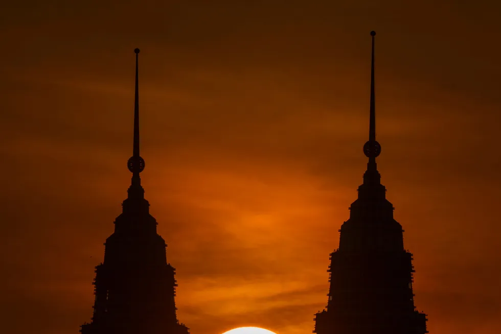 Headquarters: the sun rising behind the Petronas Twin Towers in Kuala Lumpur, Malaysia