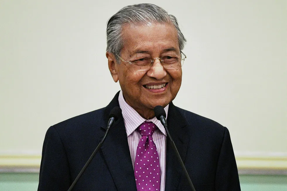 Remaining upbeat: Malaysia's interim Prime Minister Mahathir Mohamad smiles during a press conference on 27 February