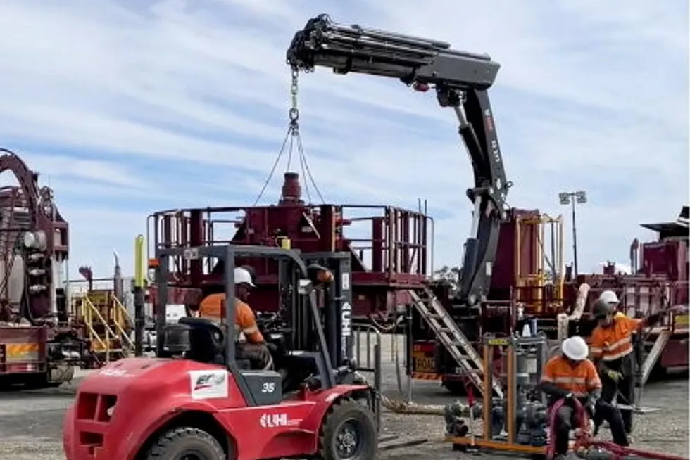 A screenshot from a video of workers preparing the site for the well test.