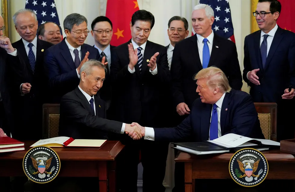 Chinese Vice Premier Liu He and US President Donald Trump shake hands after signing Phase 1 of the US-China trade agreement during a ceremony in the East Room of the White House in Washington