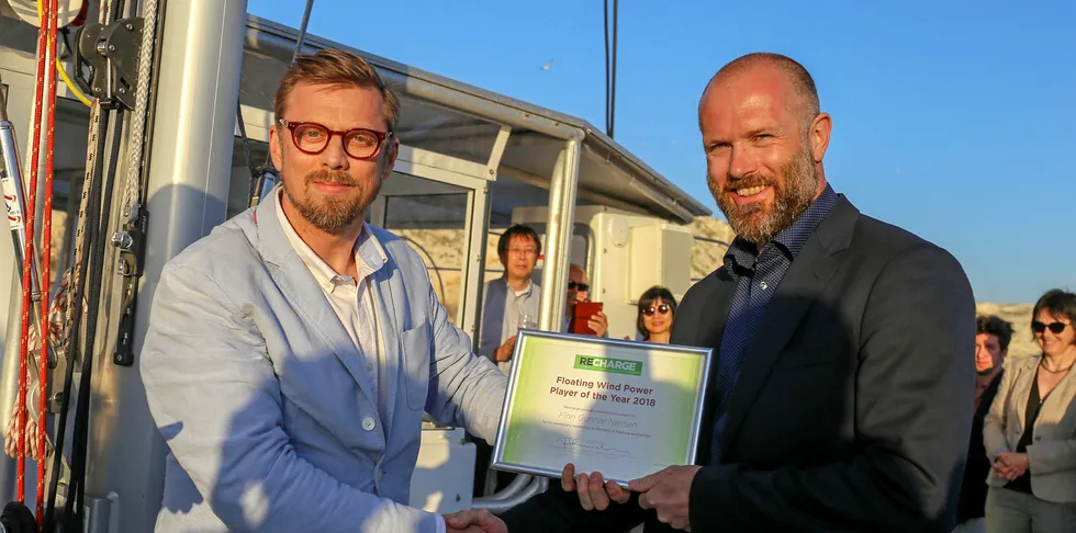 Sebastian Bringsvaerd (right) collects the Recharge Floating Wind Power Player of the Year award on behalf of Finn Gunnar Nielsen from Editor-in-Chief Darius Snieckus.