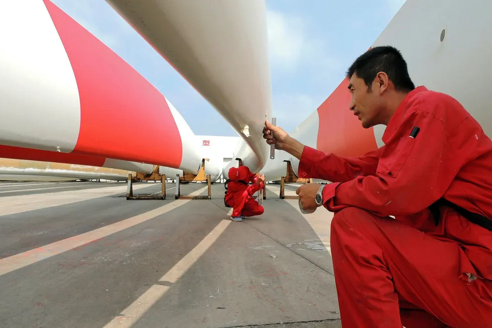 Clean power: Labourers check the quality of wind turbine blades in a factory in Lianyungang, in eastern China's Jiangsu Province