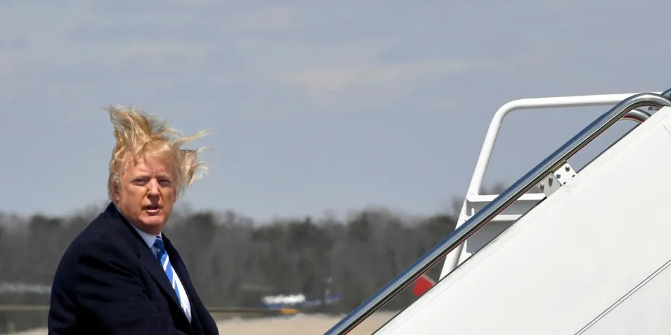 US President Donald Trump boards Air Force One on a windy day at Andrews Air Force base on April 5, 2018 near Washington, DC.
