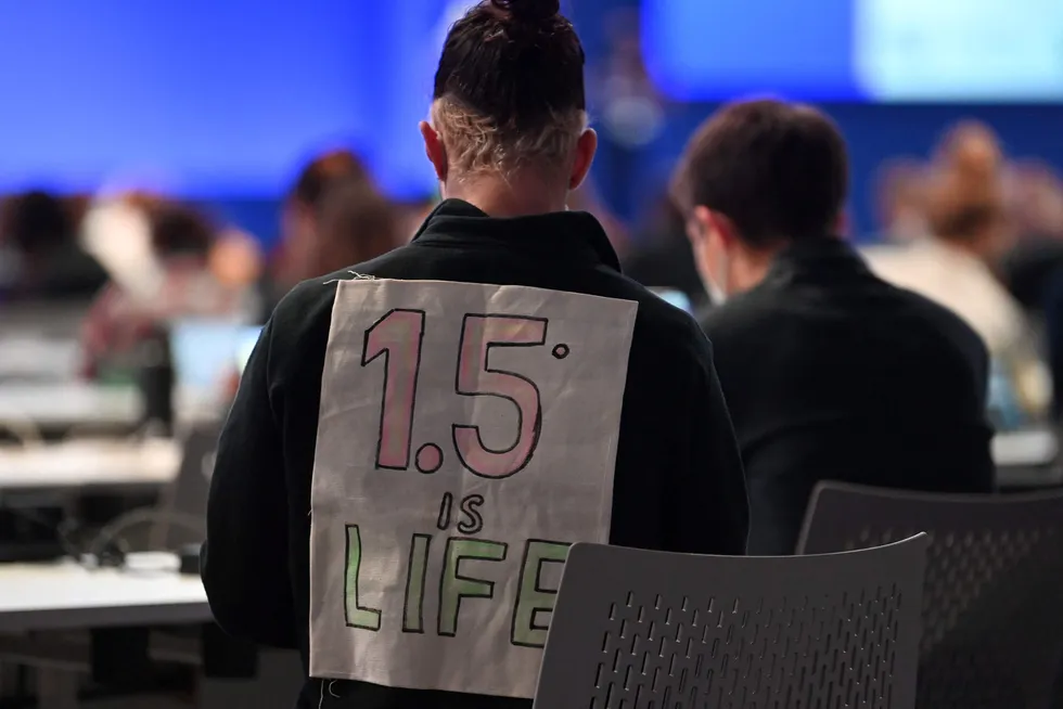 Temperature rise: A delegate bearing a message on his back, "1.5C is life", attends the People's Plenary during the COP26 UN Climate Change Conference in Glasgow.