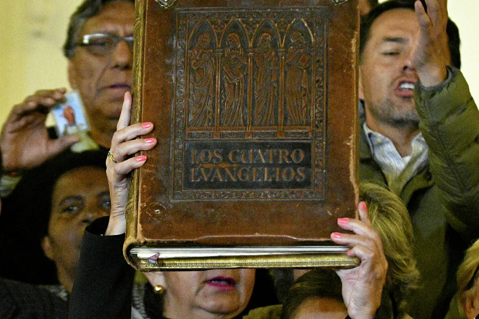 Bolivian elections: Deputy Senate speaker Jeanine Anez raises the book of gospels after proclaiming herself the country's interim president on November 12, 2019