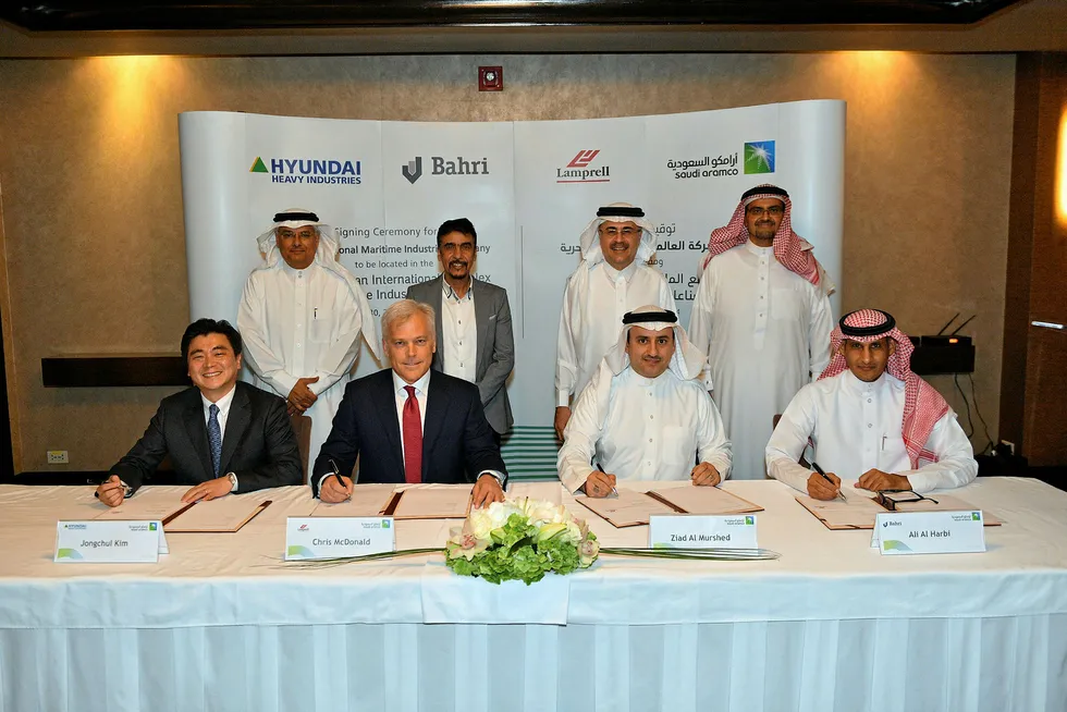 In it together: Saudi Aramco chief executive Amin Nasser (back row, second from right) looks on as the deal is signed by (from left) Hyundai Heavy Industries vice president new business development Jongchul Kim, Lamprell chief executive Chris McDonald, Saudi Aramco head of transaction development Ziad Al Murshed and Bahri acting chief executive Ali Al Harbi