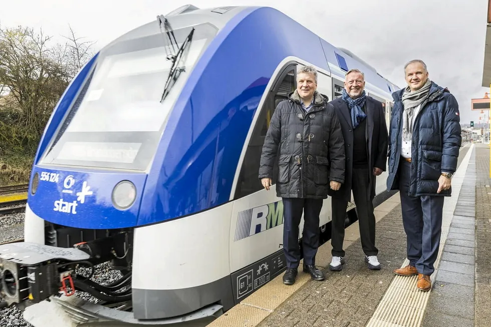 (L-R) RMV supervisory board chairman Ulrich Krebs, RMV managing director Knut Ringat, and mayor of Usingen Steffen Wernard in front of a train on the RB15 line at Usingen station.