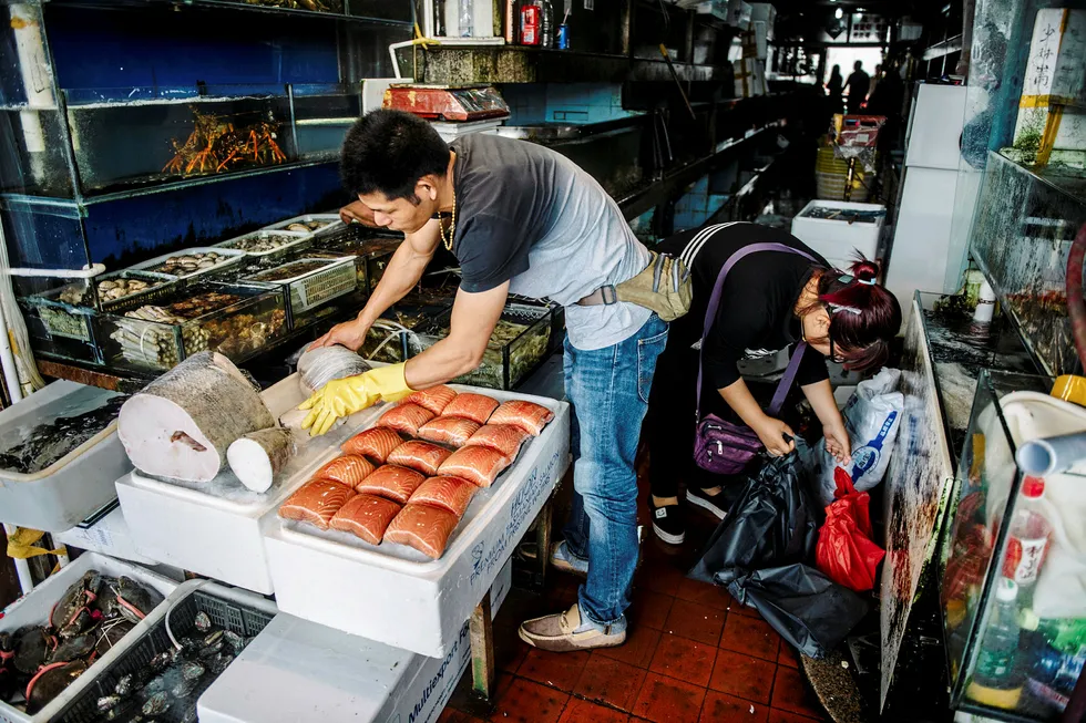 Fresh salmon fillet portions in a Shanghai market. The latest COVID-19 outbreak in China has been linked to a seafood market, including a cutting board used to process salmon.