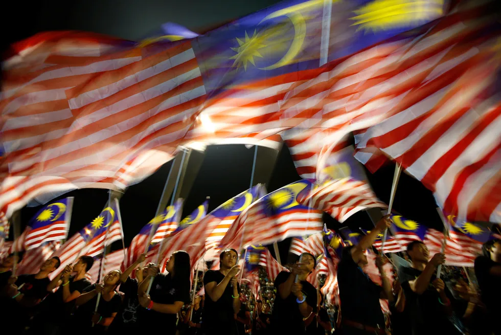 Locals wave Malaysian flags during celebrations in 2012.