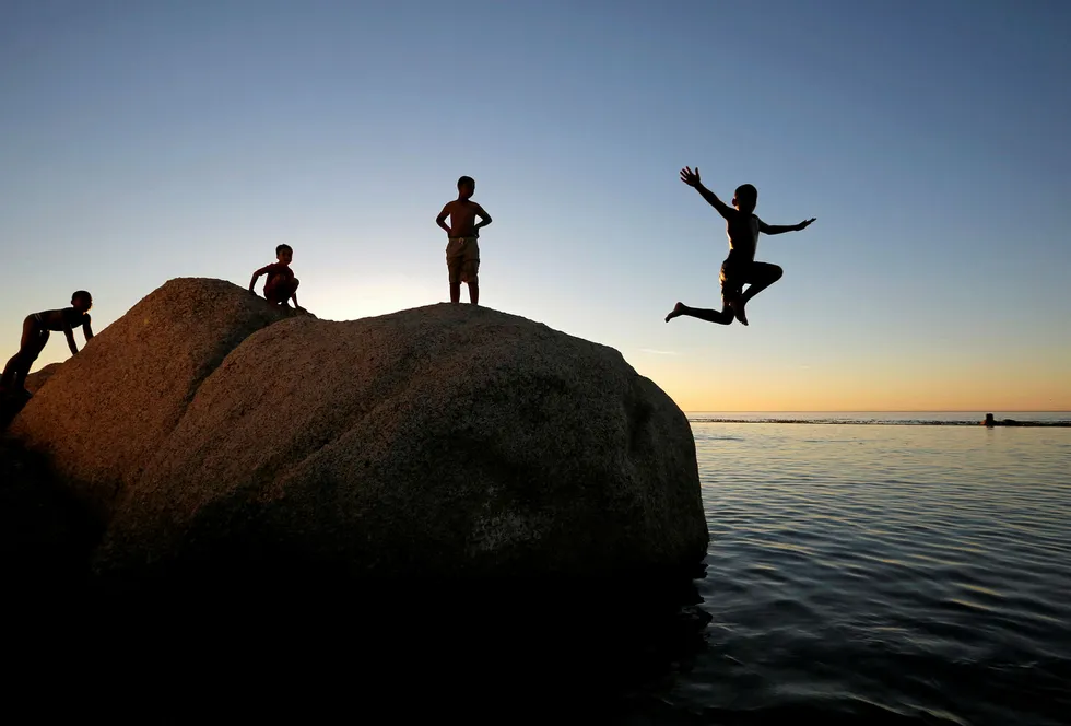 Taking the plunge: children leap into a tidal pool in Cape Town, South Africa