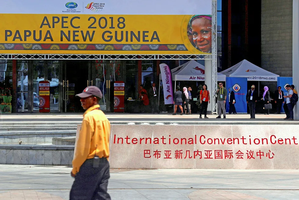 On the scene: a security guard stands near the entrance to the Convention Centre promoting the APEC forum in Port Moresby, Papua New Guinea, last November