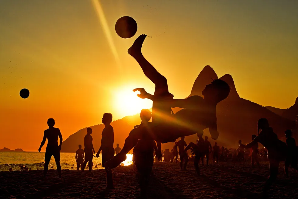 Brazil plans: beachgoers play football at sunset on Ipanema Beach in Rio de Janeiro, Brazil