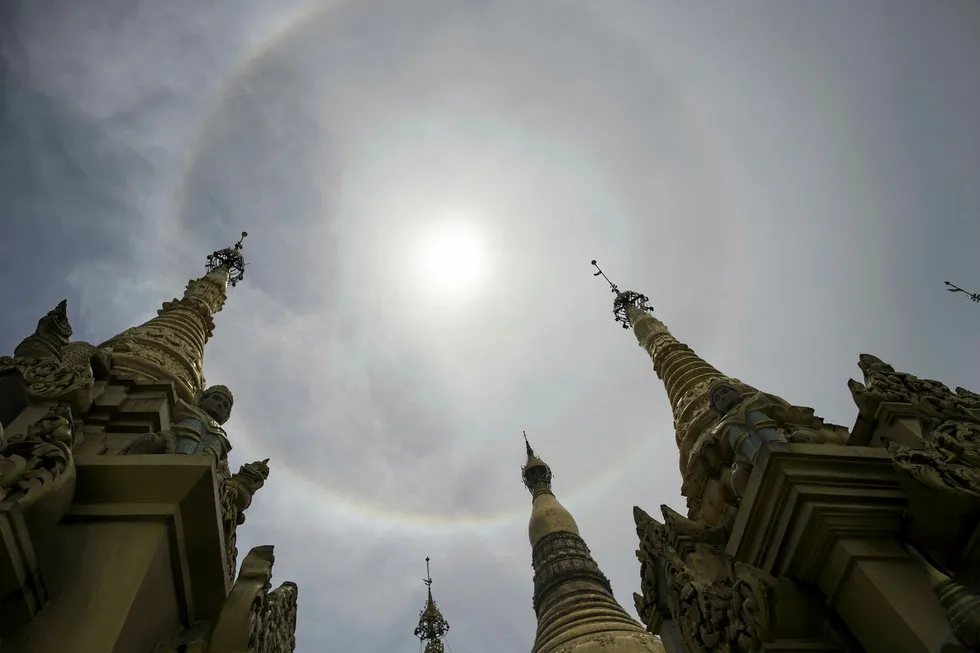 Tenders: a halo surrounding the sun over the Myanmar's Shwedagon Pagoda in Yangon