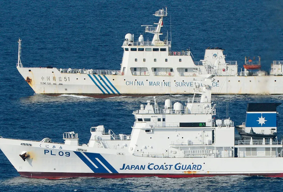 Ships of China Marine Surveillance and Japan Coast Guard side by side near disputed islands, called Senkaku in Japan and Diaoyu in China, in the East China Sea.