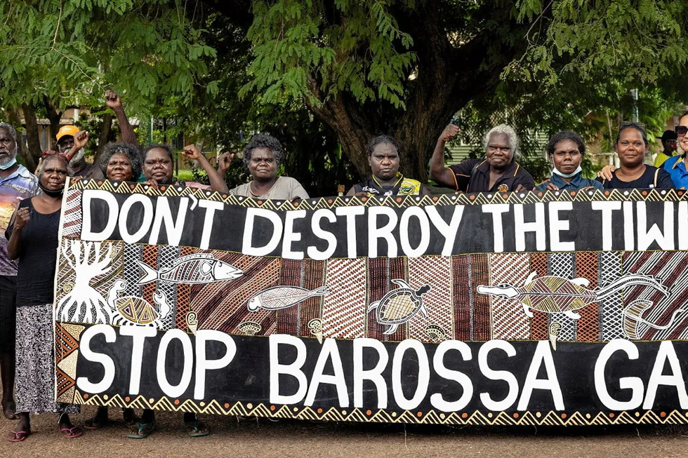 Demonstration: Tiwi Islanders holding banner to protest Santos' Barossa gas project in Australia.