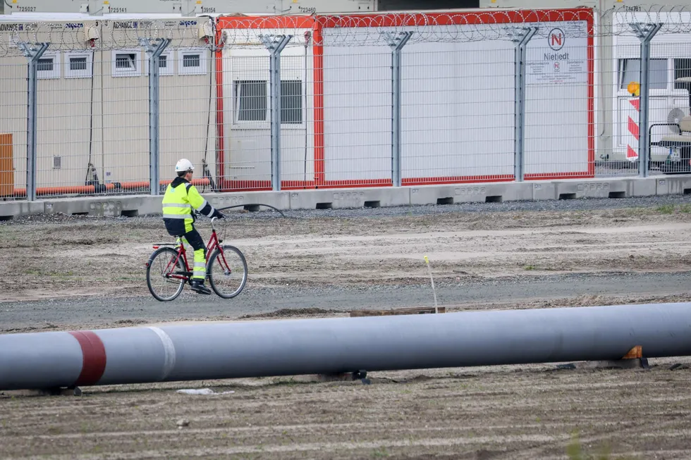 Under construction: a worker rides a bike next to the future Uniper LNG terminal in Wilhelmshaven, Germany